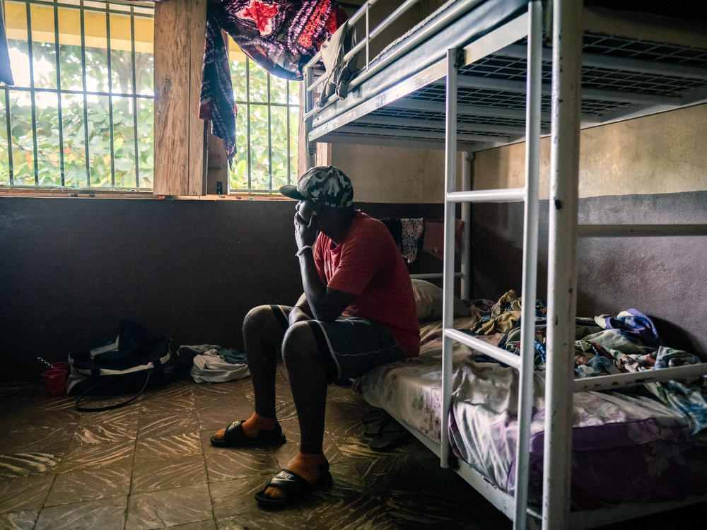 Kush user Ahmed Kang, 30, sits on his bunk at the City of Rest rehabilitation center in Grafton, Sierra Leone. Kang, who is on his third stint at the facility, says it took ten police officers to drag him inside. 
