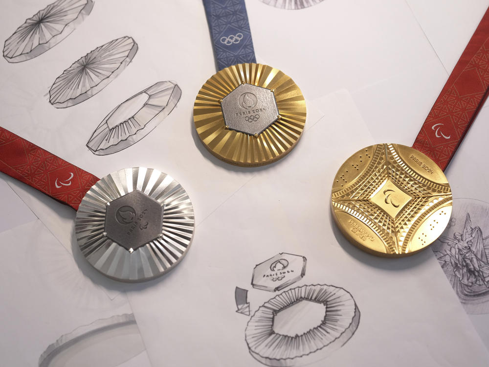 The Paris 2024 Olympic gold medal, center, the Paris 2024 Paralympic, gold medal, right, and silver medal, left, are presented to the press, in Paris, Thursday, Feb. 1, 2024.