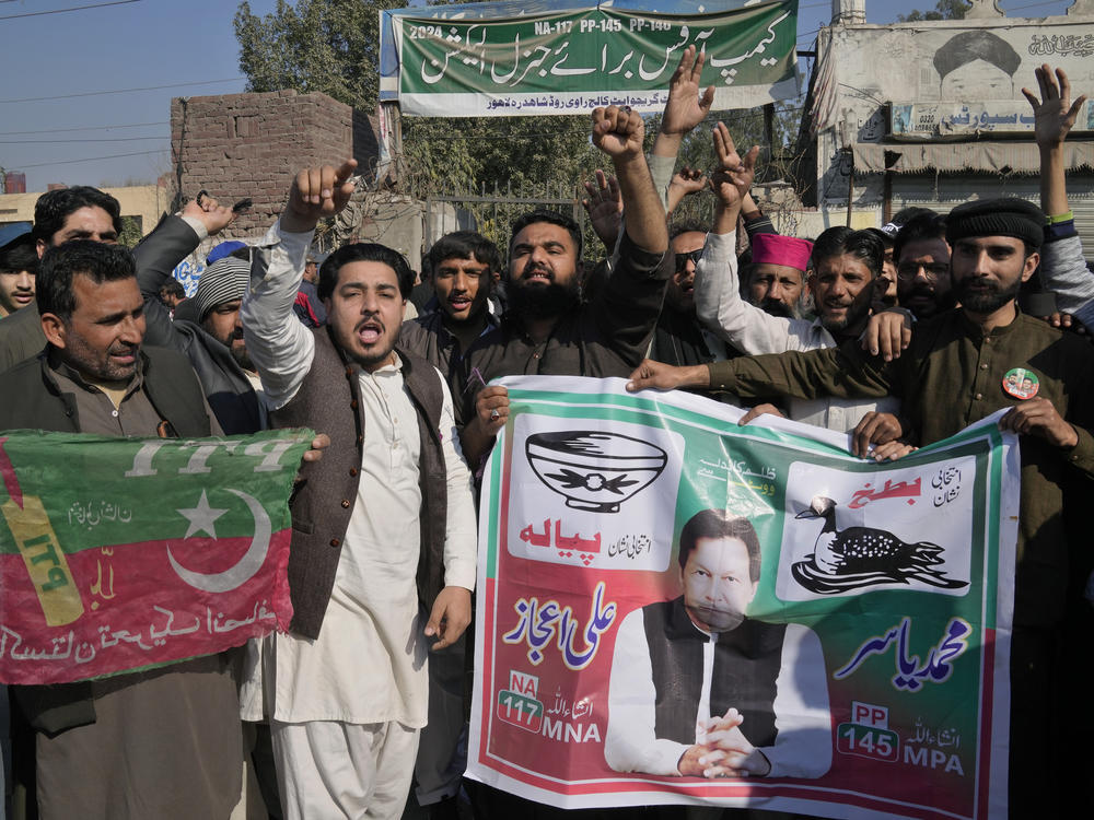Supporters of the party of Pakistan's imprisoned former prime minister, Imran Khan, block a road as a protest against the delaying result of parliamentary election by Pakistan Election Commission, in Lahore, Pakistan, Friday.