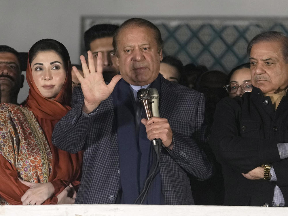Pakistan's former Prime Minister Nawaz Sharif (center) addresses supporters next to his brother, Shehbaz Sharif (right) and daughter Maryam Nawaz following initial results of the country's parliamentary election, in Lahore, Pakistan, Friday.