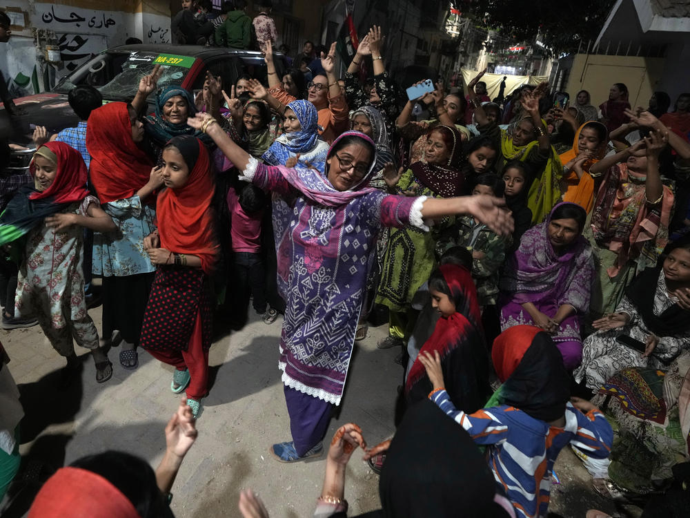 Supporters of Bilawal Bhutto Zardari, chairman of Pakistan People's Party, dance to celebrate initial results of the country's parliamentary election, in Karachi, Pakistan, Friday.