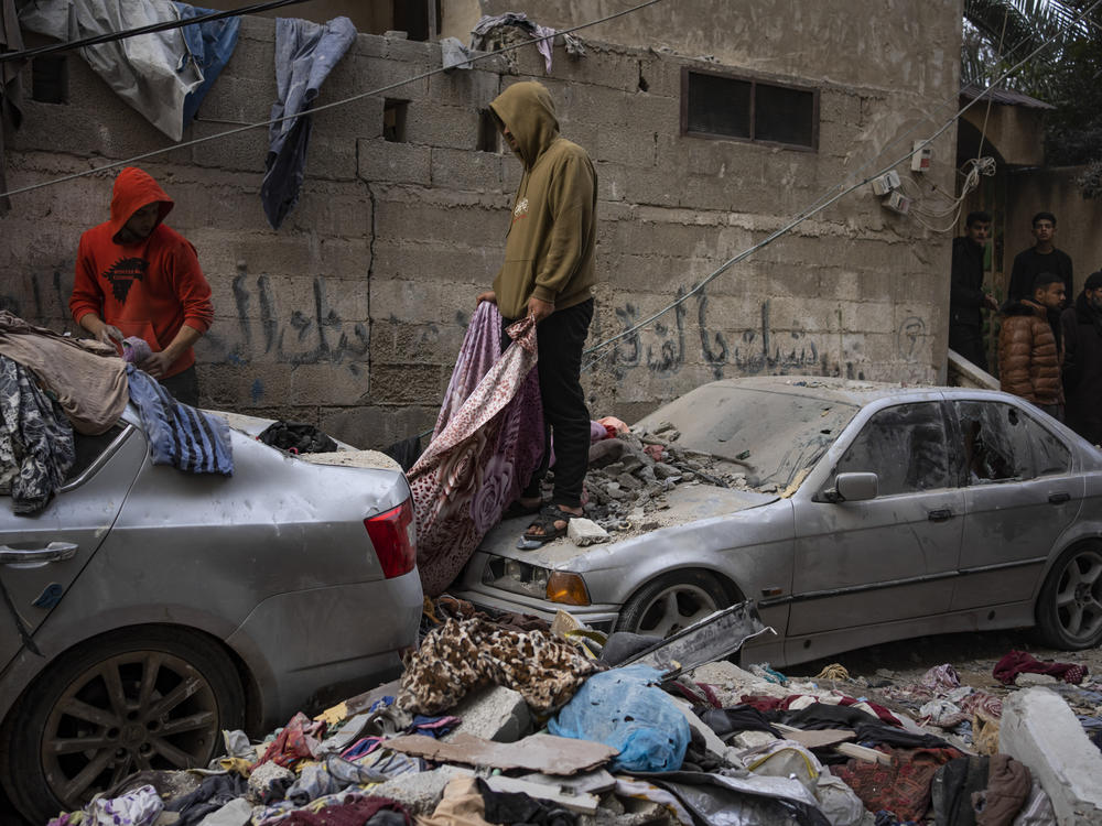 Palestinians look at the destruction after an Israeli airstrike in Rafah, Gaza Strip, Friday, Feb. 9, 2024. (AP Photo/Fatima Shbair)