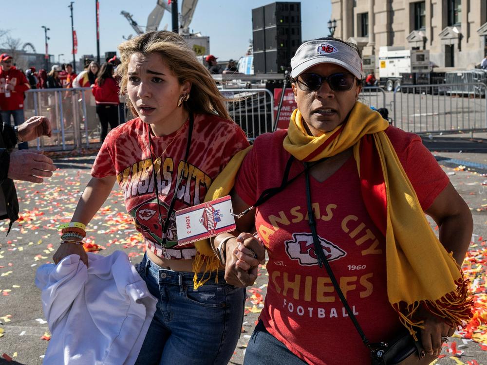 People flee after shots were fired near the Kansas City Chiefs' Super Bowl victory parade on Feb.14 in Kansas City, Mo.