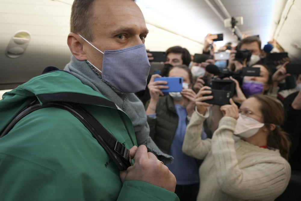Navalny is surrounded by journalists inside the plane as he walks to his seat on Jan. 17, 2021.