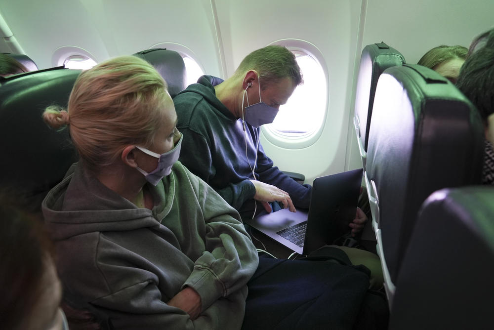 Navalny and his wife Yulia sit in the plane and watch <em>Rick and Morty</em> together on Jan. 17, 2021.