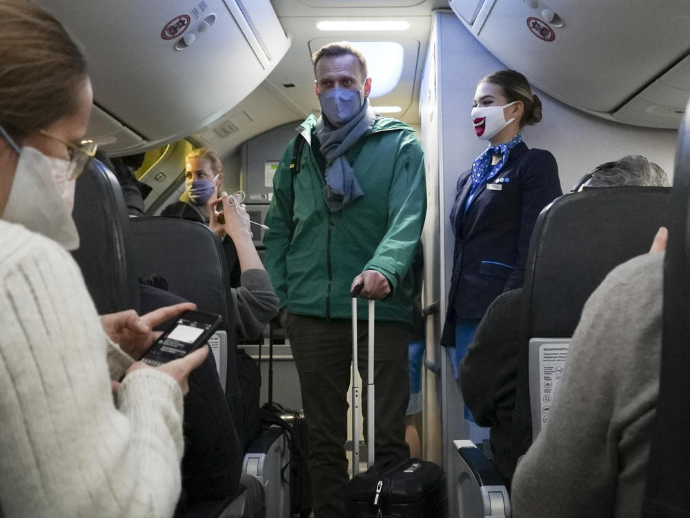 Alexei Navalny and his wife Yulia board the plane prior to flight to Moscow in the Berlin Brandenburg Airport in Schoenefeld, near Berlin, on Jan. 17, 2021.