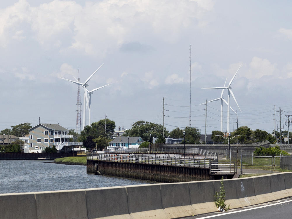 Wind turbines are visible from the highway in Atlantic City, New Jersey. The state and the country are betting big  on offshore wind power as a means to combat climate change.