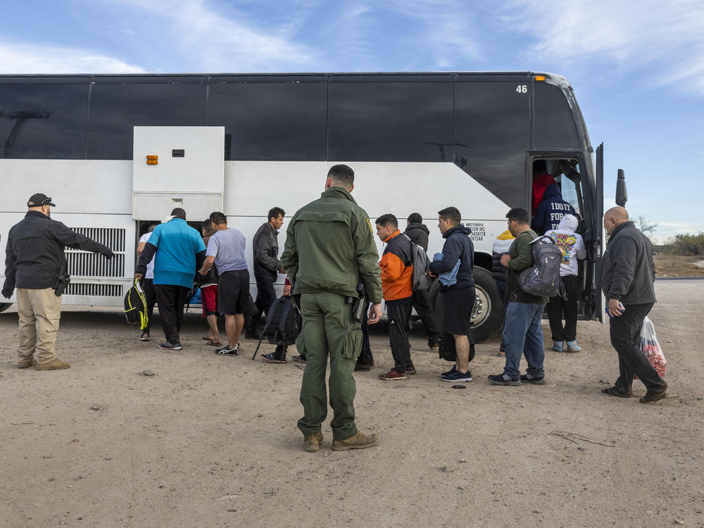 Immigrants file into a U.S. Customs and Border Protection bus after crossing the U.S.-Mexico border on January 07, 2024 in Eagle Pass, Texas.