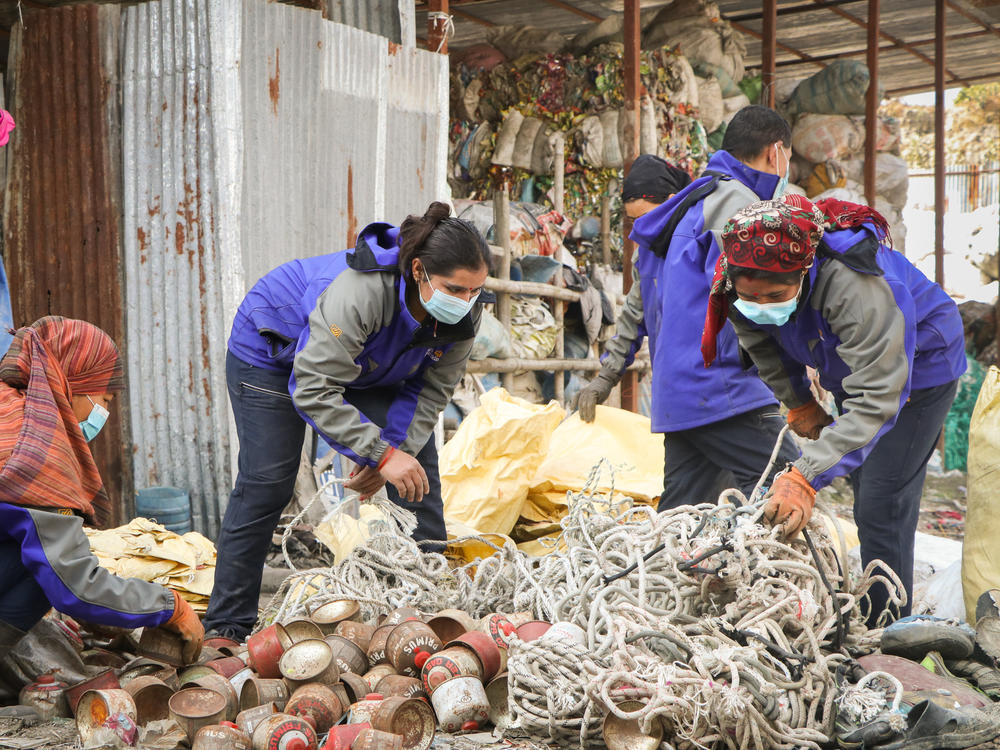 Workers separate waste collected from the mountains at the waste storage site in Tokha, Kathmandu.
