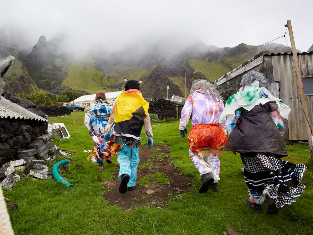 A group of Okalolies head toward a house belonging to one of their own in Edinburgh of the Seven Seas on Tristan da Cunha, in the South Atlantic Ocean, on Dec. 31, 2023. New Year's Eve, or Old Year's Night as it's known on the island, is a chance for the whole community to come together.