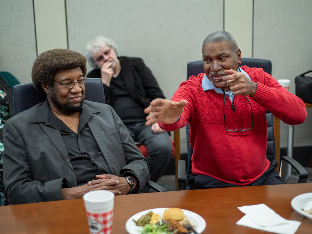 Dr. Donald Cole, right, describes having a gun pointed at him when Black protesters were arrested in 1970 after storming the stage during a concert by the group 