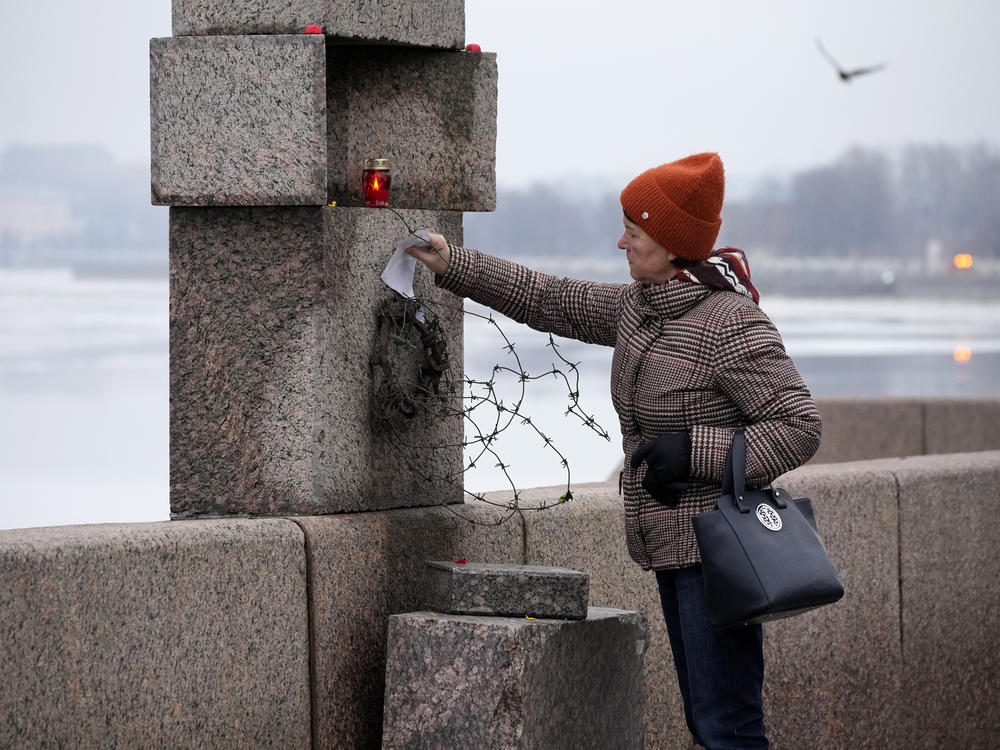 A woman places a piece of paper with words of grief for Alexei Navalny paying the last respect to him at the Memorial to Victims of Political Repression in St. Petersburg, Russia, on Saturday.