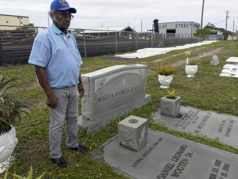 Elijah Wooten stands near the graves of many of his family members at the Westview Community Cemetery.