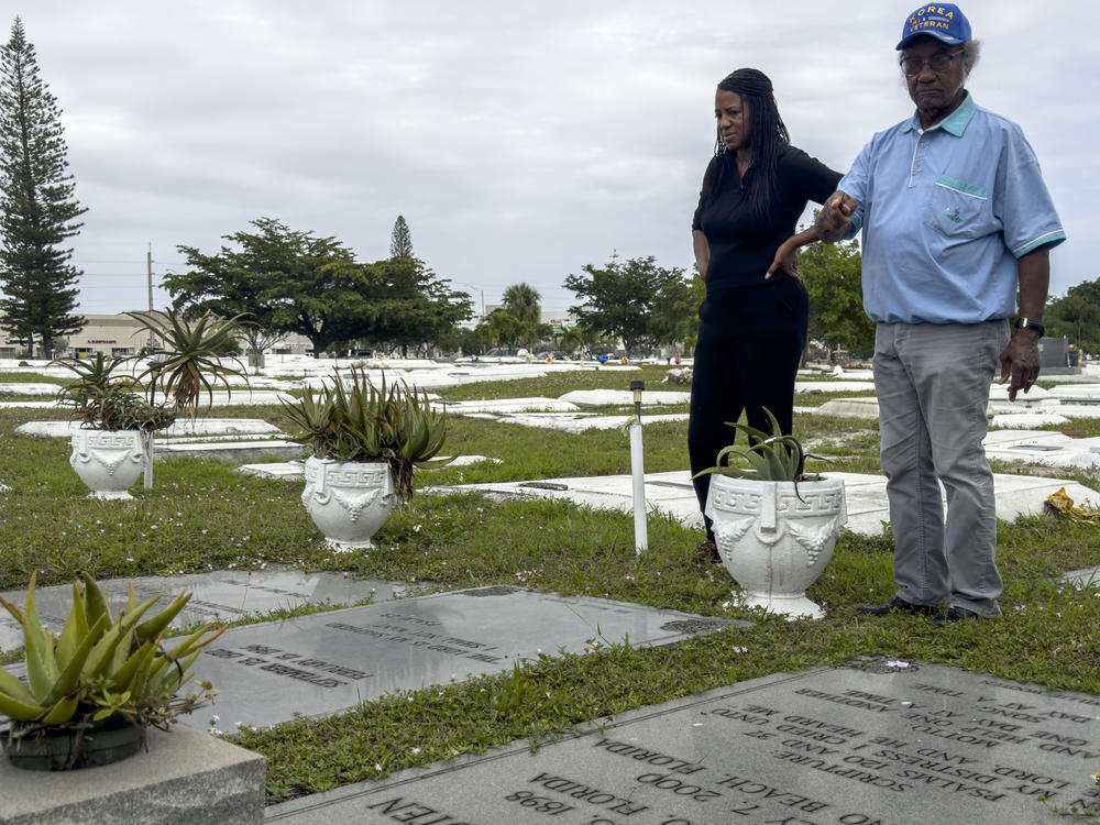 Sonya Williams-Finney and Elijah Wooten look over graves of Wooten's family members.