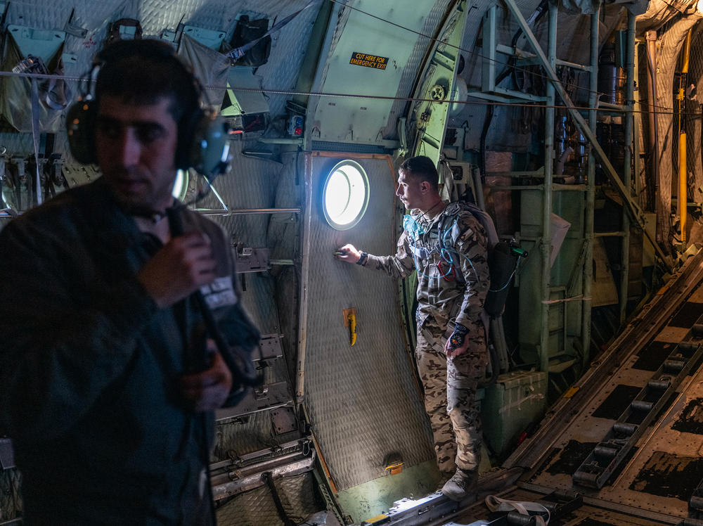 Jordanian air force personnel inside a C-130 aircraft after airdropping pallets of aid over Gaza on Thursday.