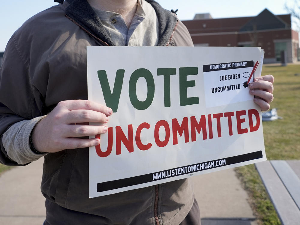 Eric Suter-Bull holds a Vote Uncommitted sign outside a voting location for the Michigan primary election in Dearborn, Mich., on Feb. 27.
