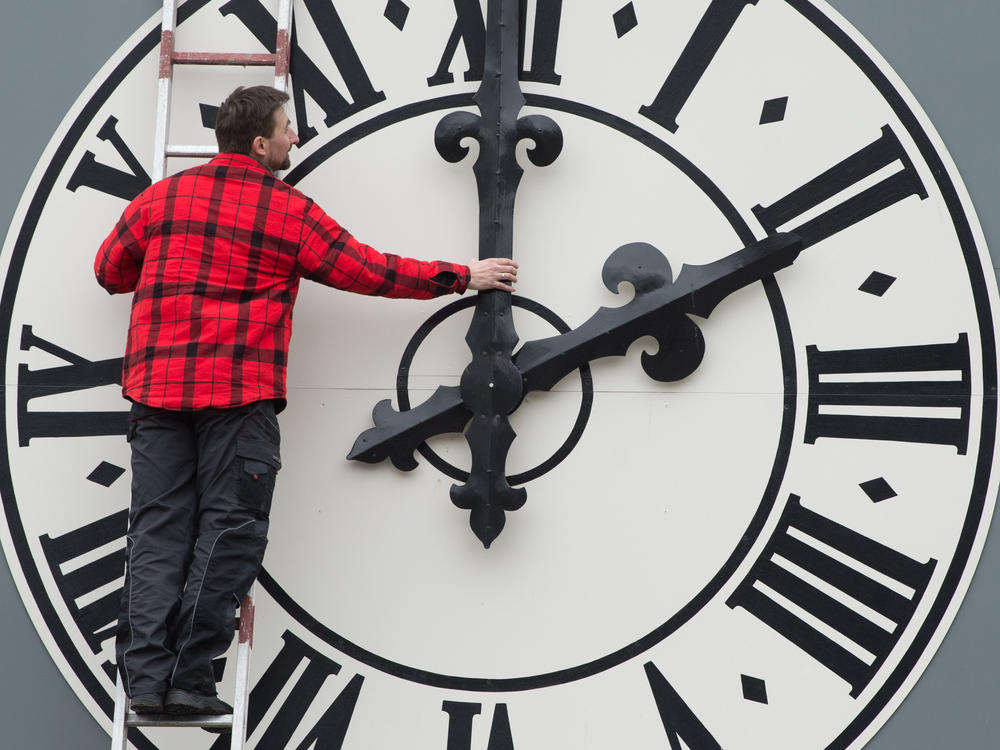 This picture taken in March 2018 shows a technician working on the clock of the Lukaskirche church in Dresden, eastern Germany.