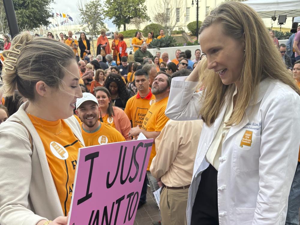 Hannah Miles of Birmingham speaks with Dr Dr. Mamie McLean outside the Alabama Statehouse in Montgomery, Ala. on Feb. 28, 2024. They were among patients and doctors urging Alabama lawmakers to take action to get IVF services in the state. Fertility clinics paused some services in the wake of a state court ruling related to whether embryos are children under a state law.