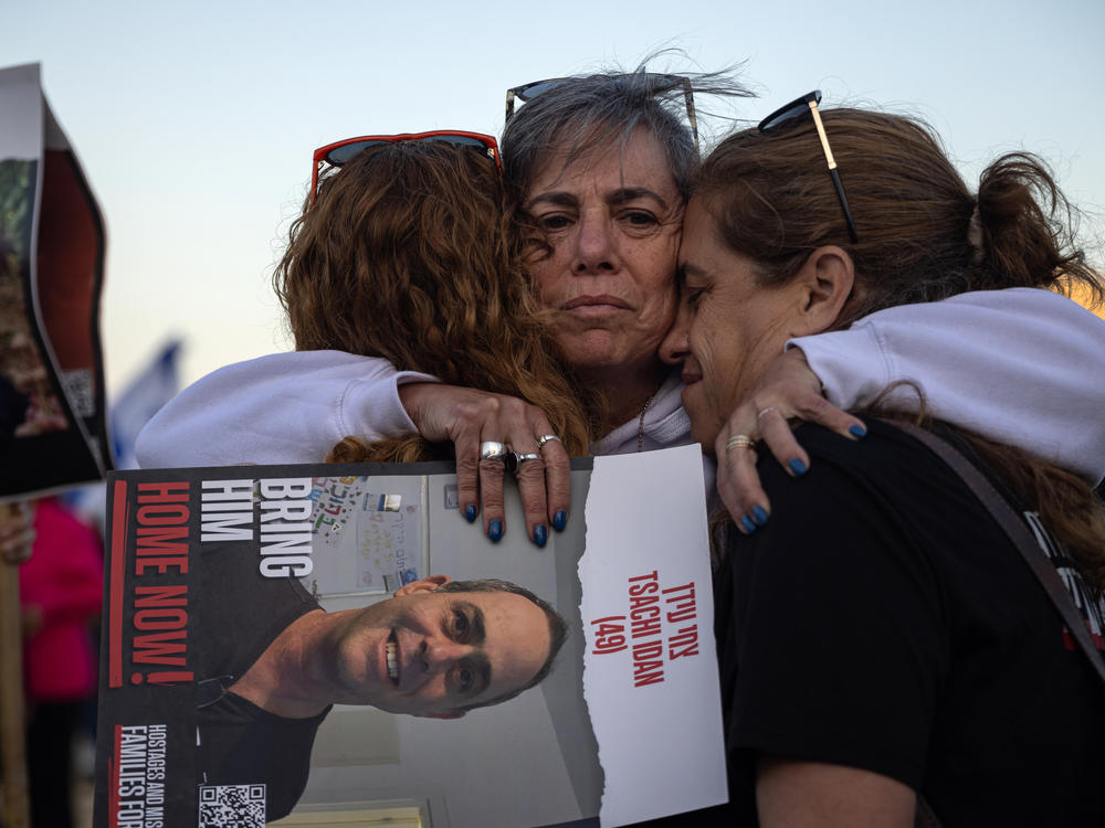 Einat Ofir embraces her cousins, Ronit Dvir and Karni Peleg, after a ceremony at the site of the former police station in Sderot, Israel on Feb. 28. The families of the Israeli hostages held a four-day march to keep attention focused on the plight of their loved ones still in captivity and to pressure the Israeli government to secure a deal that would release them.