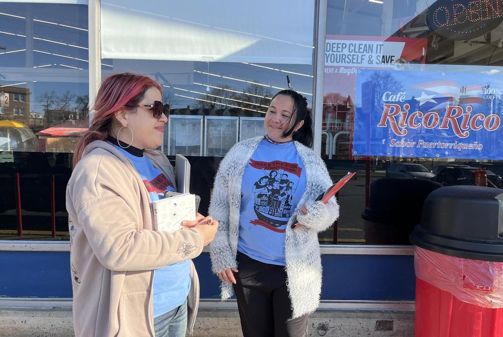Katherine De Peña, left, a field organizer in charge of Make The Road Pennsylvania's voter registration program, and her colleague Mayra Del Toro wait to greet eligible voters in Spanish outside a CTown supermarket in Reading, Pa.