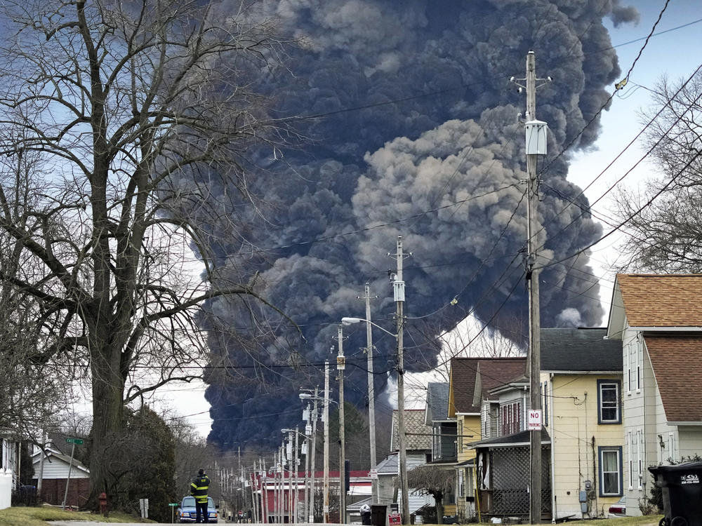 A black plume rises over East Palestine, Ohio, after the derailment of a Norfolk Southern train in February, 2023.