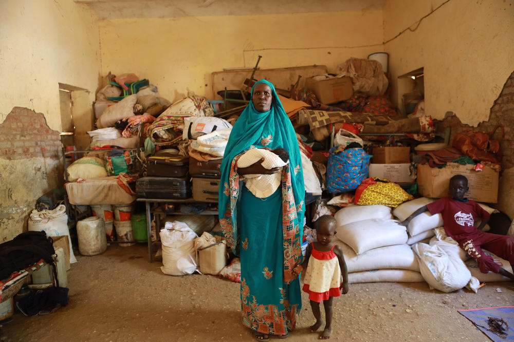 Mary Monga was forced to flee her home in Khartoum with her children. She posed for a portrait on Dec. 10, 2023. She says, 
