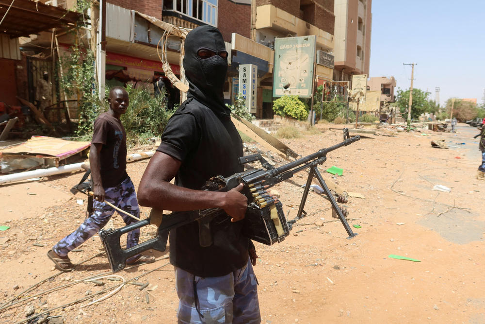 A member of Sudanese armed forces looks on as he holds his weapon in the street in Omdurman, Sudan, March 9.