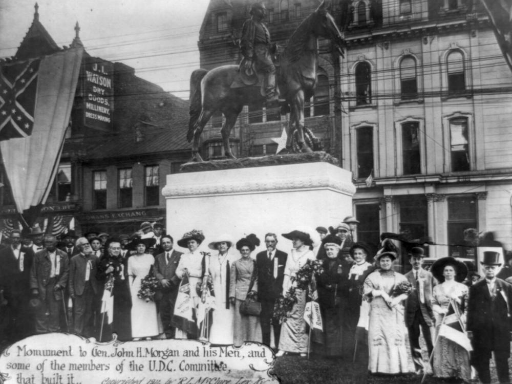 Members of the United Daughters of the Confederacy stand in front of a monument they commissioned of Confederate Gen. John Hunt Morgan and his men in Lexington, Ky., in 1911. The group has put up more than 600 markers and monuments to the Confederacy nationwide.