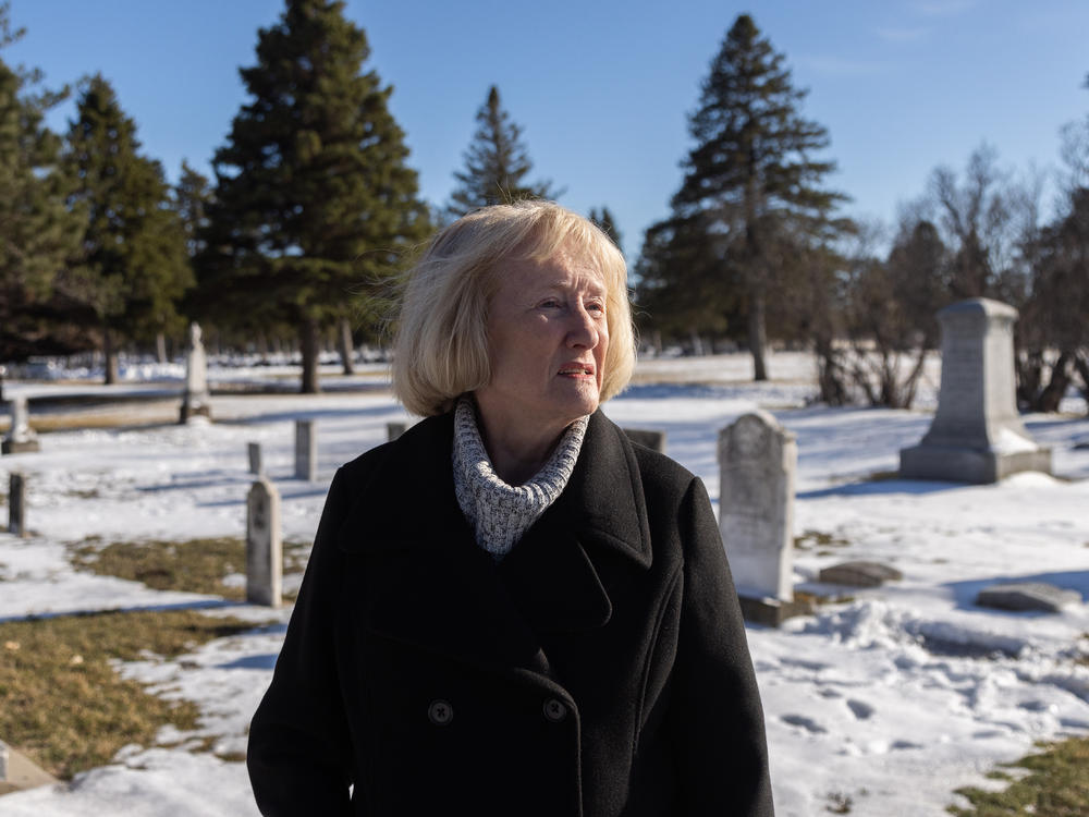 Darla Gebhard walks through the New Ulm City Cemetery, where many settlers who died in the U.S.-Dakota wars are buried.