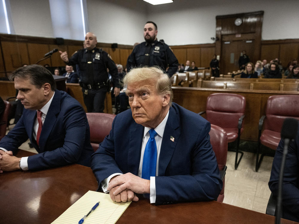Former President Donald Trump looks on at Manhattan criminal court Monday, during his trial for allegedly covering up hush money payments linked to extramarital affairs.