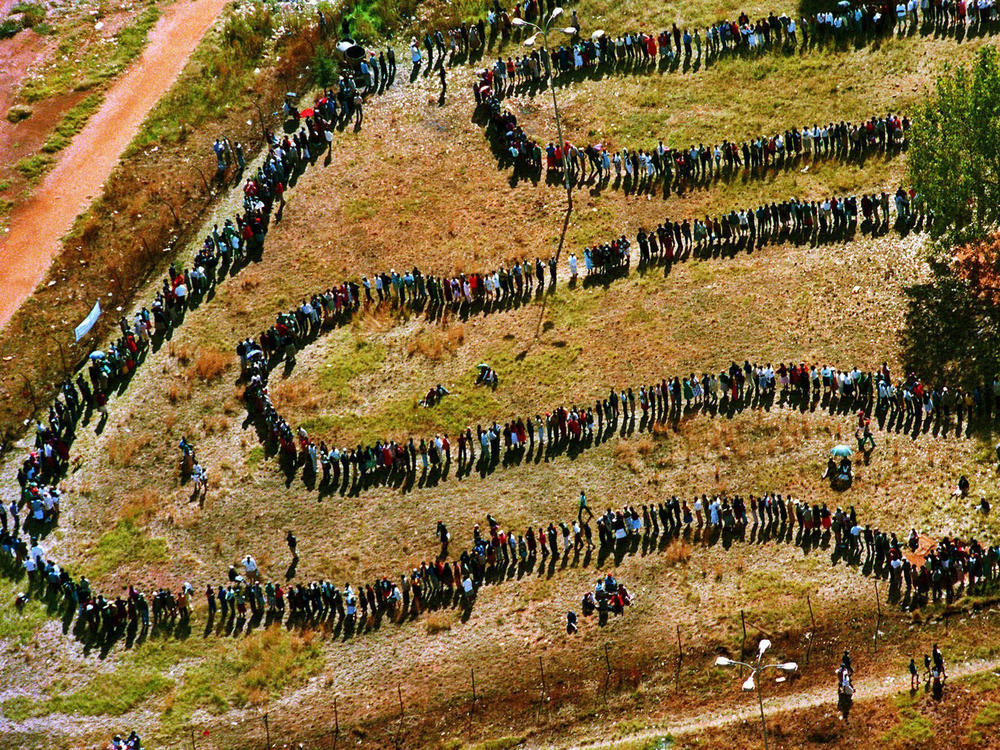 People queue to cast their votes In Soweto, South Africa April 27, 1994, in the country's first all-race elections. South Africans celebrate 