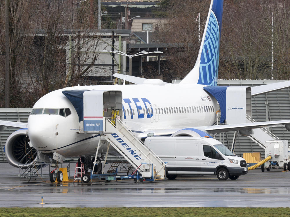 A person walks past a Boeing 737 Max 8 for United Airlines parked at Renton Municipal Airport adjacent to Boeing's factory in Renton, Wash., on Jan. 25.