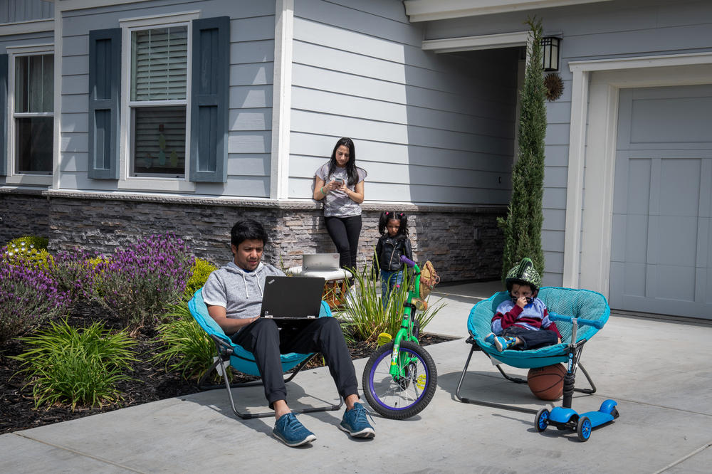 Weeks into the pandemic, Aishwarya Ramaswamy (left) and Mukundan Swaminathan worked to juggle their careers and parenthood out of their Union City, Calif., home in April 2020, as they tried to keep their kids, Krish and Mayura, entertained.