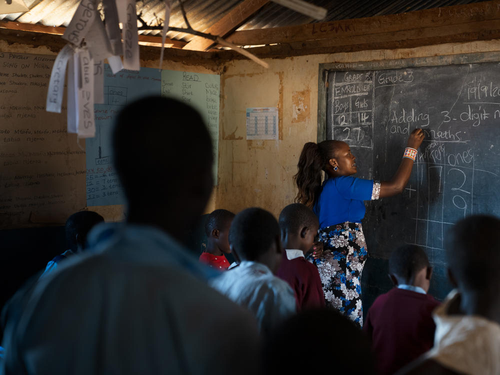The third-grade teacher, Florence Lerapayo, teaches a math lesson. She says when Paris first arrived in her classroom he seemed uneasy and adrift.