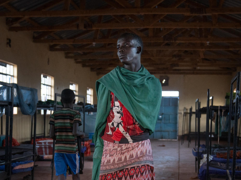 Paris stands in his dormitory at the primary school. At 15, he is starting school for the first time.