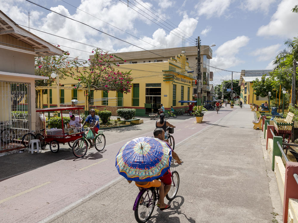 People cycle along the street in Afuá, a city in northern Brazil's Pará state, in January. <strong></strong>Since 2002, this city on the banks of the Amazon River has been famously off limits to motor vehicles.