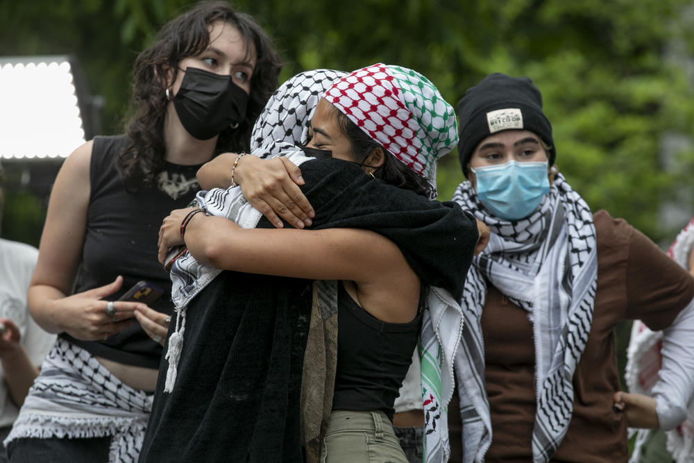 Pro-Palestinian protestors hug each other on George Washington University's campus in Washington, D.C. on May 9, 2024.