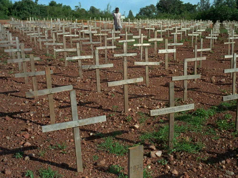 A young Rwandan girl walks through Nyaza cemetery outside Kigali, Rwanda in November 1996 where thousands of victims of the 1994 genocide are buried.