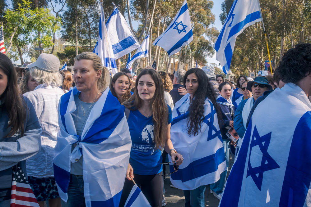 Pro-Israel counter-protesters wear and wave Israeli flags near the UC San Diego pro-Palestinian encampment, May 5, 2024.