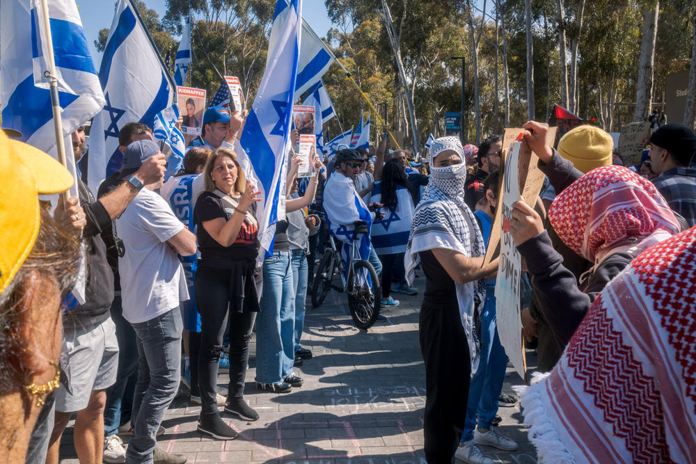 Pro-Israel counter-protesters hold Israeli flags outside the pro-Palestinian encampment at UC San Diego, May 5, 2024.