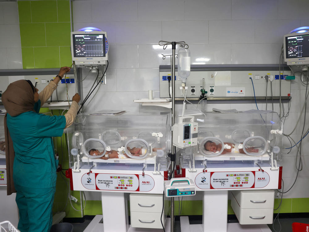 A Palestinian medic cares for babies born preterm at a hospital in Rafah in the southern Gaza Strip on April 24.