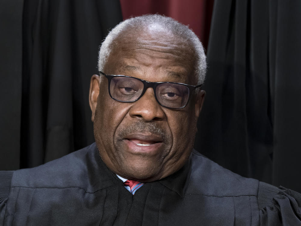 Justice Clarence Thomas poses for a photo at the Supreme Court building in Washington on Oct. 7, 2022. Thomas told attendees at a judicial conference Friday that he and his wife have faced 
