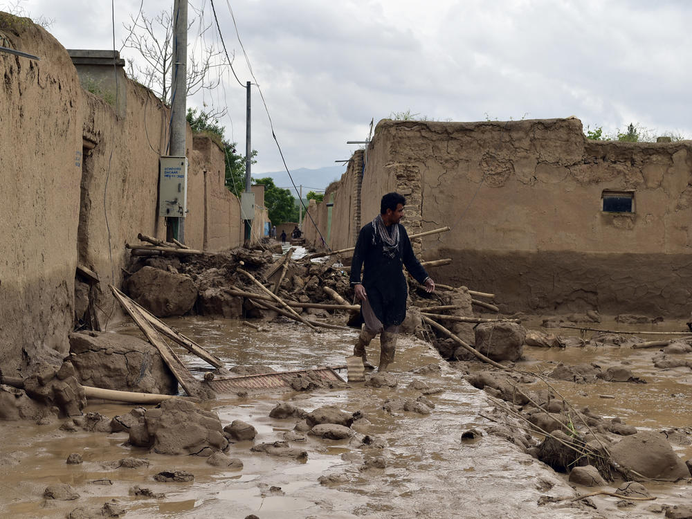 A man walks near his damaged home after heavy flooding in Baghlan province in northern Afghanistan on Saturday.