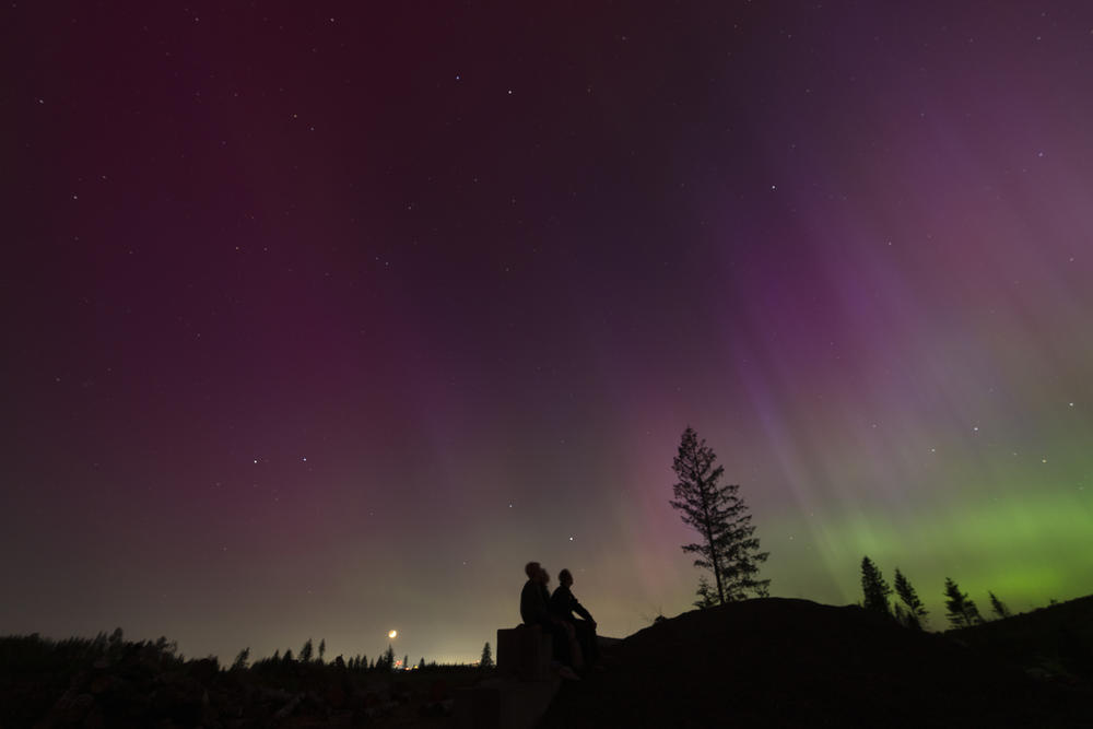 Estacada, Oregon: In this image taken with a long exposure, people look at the night sky towards the northern lights, or Aurora Borealis, on Friday, May 10, 2024.