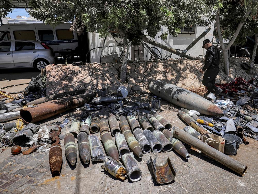 Explosives experts of Hamas lay out unexploded projectiles from the aftermath of the May 2021 conflict with Israel, at a local police precinct in Gaza City on June 5, 2021.