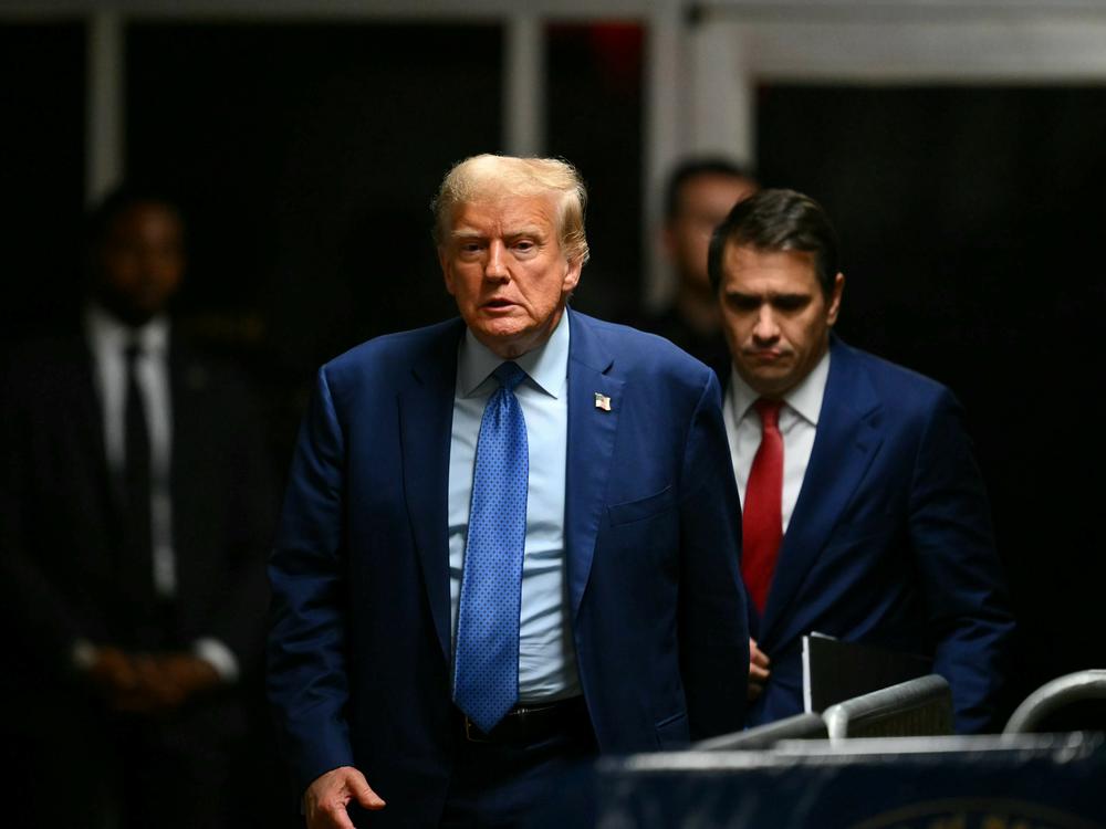 Former President Donald Trump walks to speak to the press at the end of the day during his trial for allegedly covering up hush money payments at Manhattan Criminal Court on Thursday in New York City.