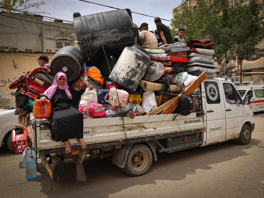 Palestinians pile their belongings on a vehicle as it drives to safer areas in Rafah, in the southern Gaza Strip, on Friday.