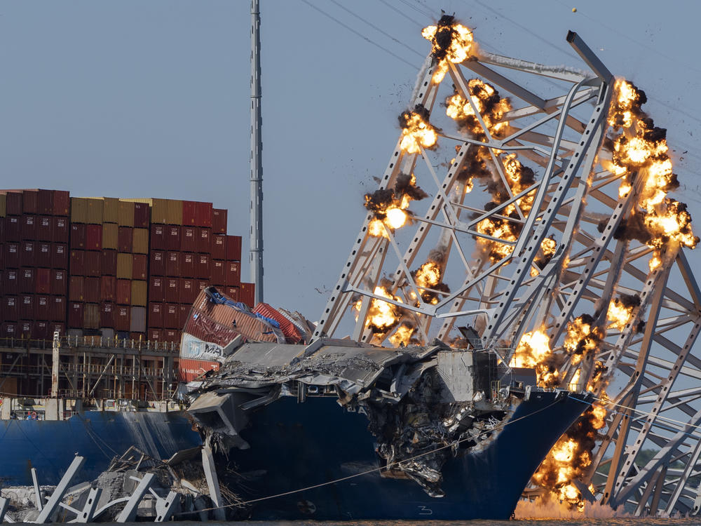 Explosive charges are detonated to bring down sections of the collapsed Francis Scott Key Bridge resting on the container ship Dali on Monday in Baltimore.
