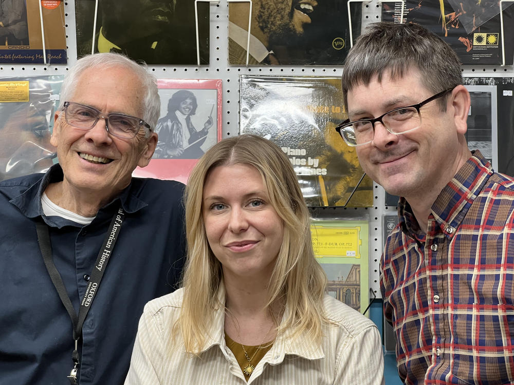 Wuxtry Records owner Dan Wall (left) with <em>World Cafe </em>host Raina Douris and store manager Nathaniel Mitchell.