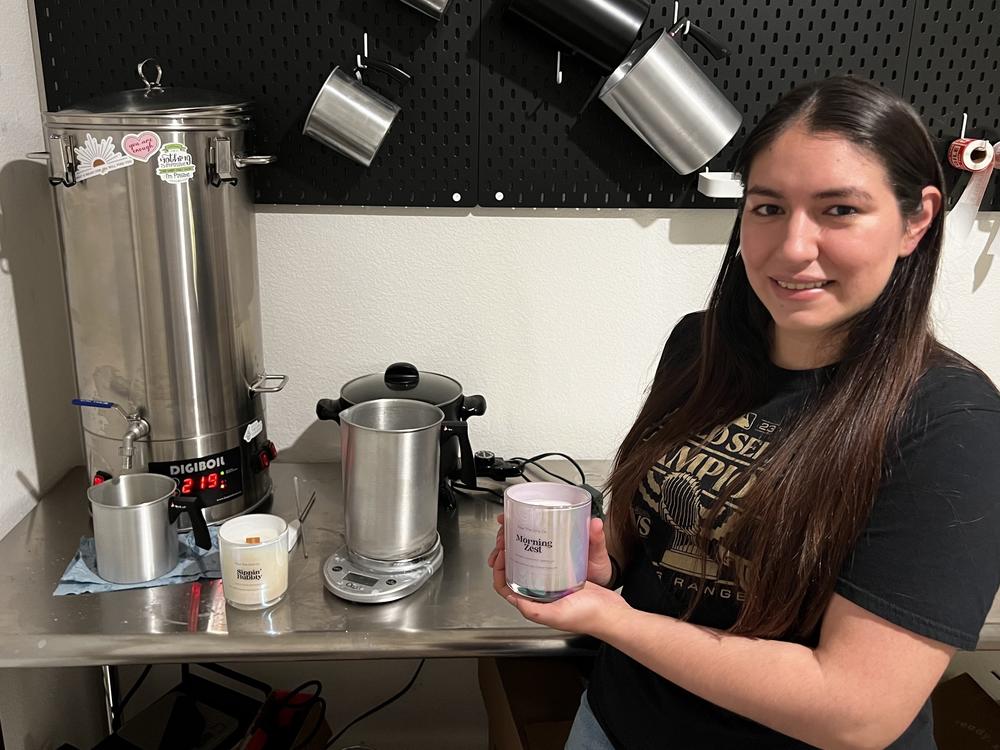 Angelica Popoca pours melted wax into a container. She recently quit her fulltime job to build her candle making venture. She now has more time to spend with her three children and enjoys running her own business in Waxahachie, Texas.